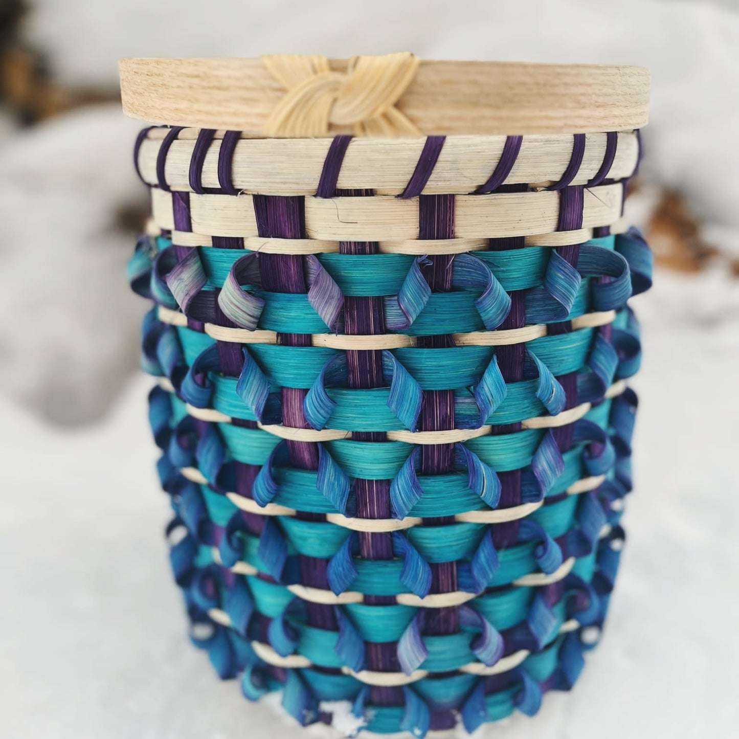 This vibrant basket kit features a stunning design with rich shades of blue and purple, complemented by lighter accents. Crafted using high-quality basket materials, it employs a unique looped weaving technique that adds texture and visual appeal. Ideal for both beginners and experienced crafters, this DIY basket kit is perfect for creating stunning storage solutions or home decor pieces. The snow-covered background enhances this beautiful basket, showcasing its artistic value and functionality. Explore the