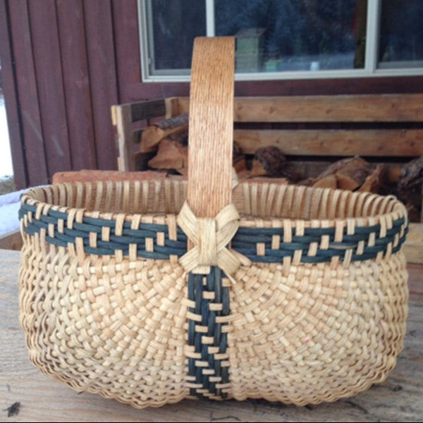 This beautifully handcrafted basket features a classic design with natural tones, showcasing intricate weaving techniques. The sturdy wooden handle adds both functionality and aesthetic appeal, making it easy to carry. The inclusion of dark woven accents enhances the overall design, giving it a sophisticated touch. Perfect for storage or decorative use, this basket exemplifies the artistry of basketry. It’s a wonderful addition for anyone passionate about crafts and basket materials. Ideal for those looking